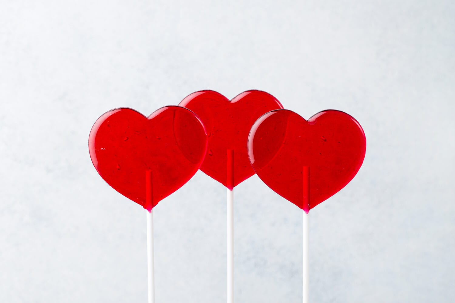 Red lollipops. Red hearts. Candy. Love and sweet concept. Valentine day. White background.