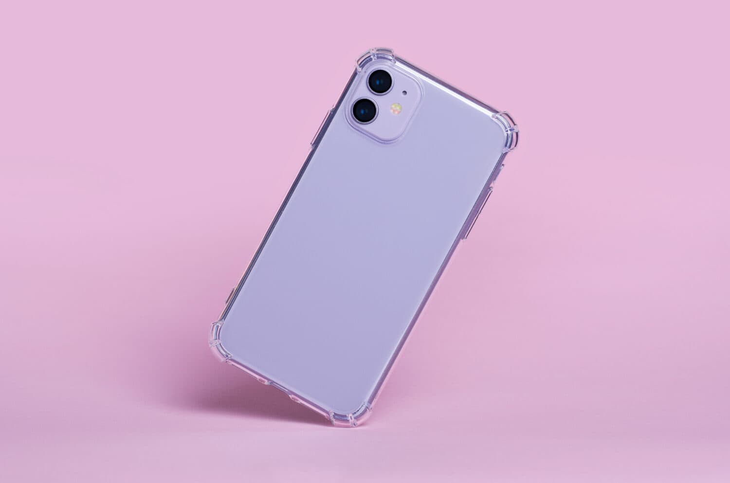 Purple iPhone 11 in clear silicone case falls down isolated on pink background. Phone case mockup back view