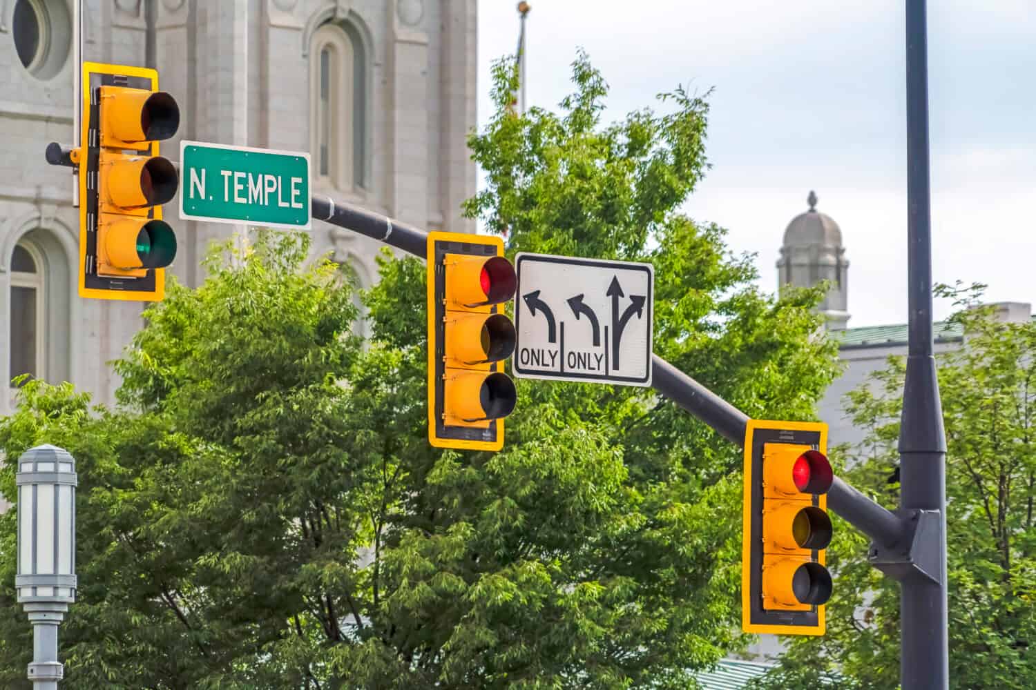 Traffic lights and road signs mounted on metal pole in Salt Lake City Utah