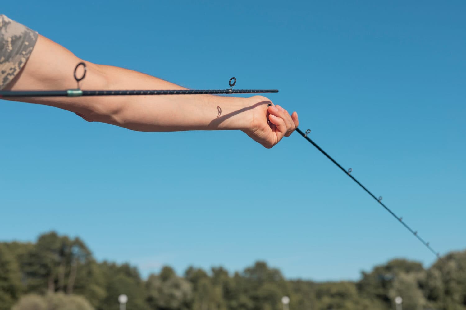 Male hands holding a broken fishing rod 