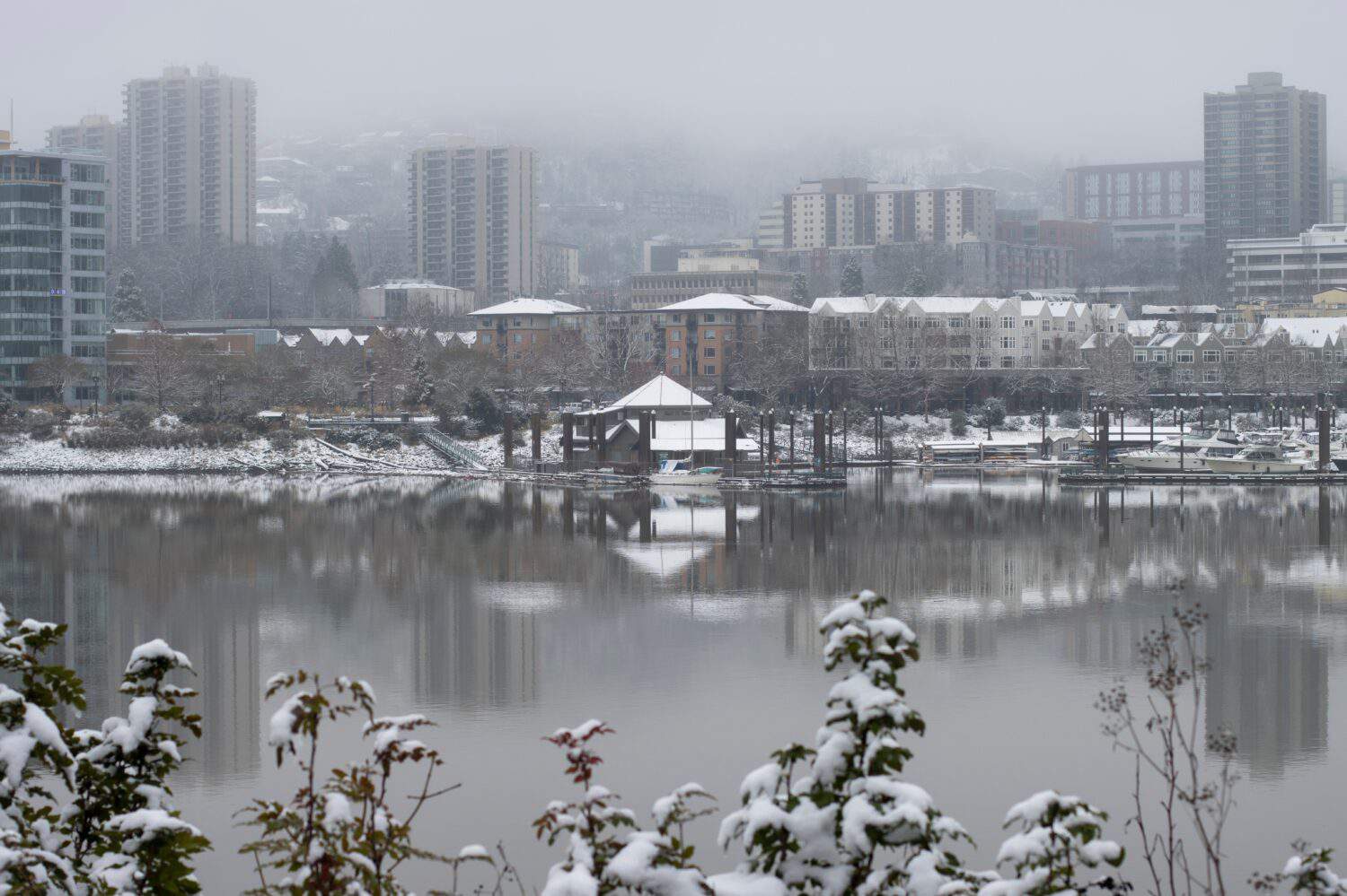 South downtown Portland viewed from Eastbank Esplanade on a cold winter day after snowfall.