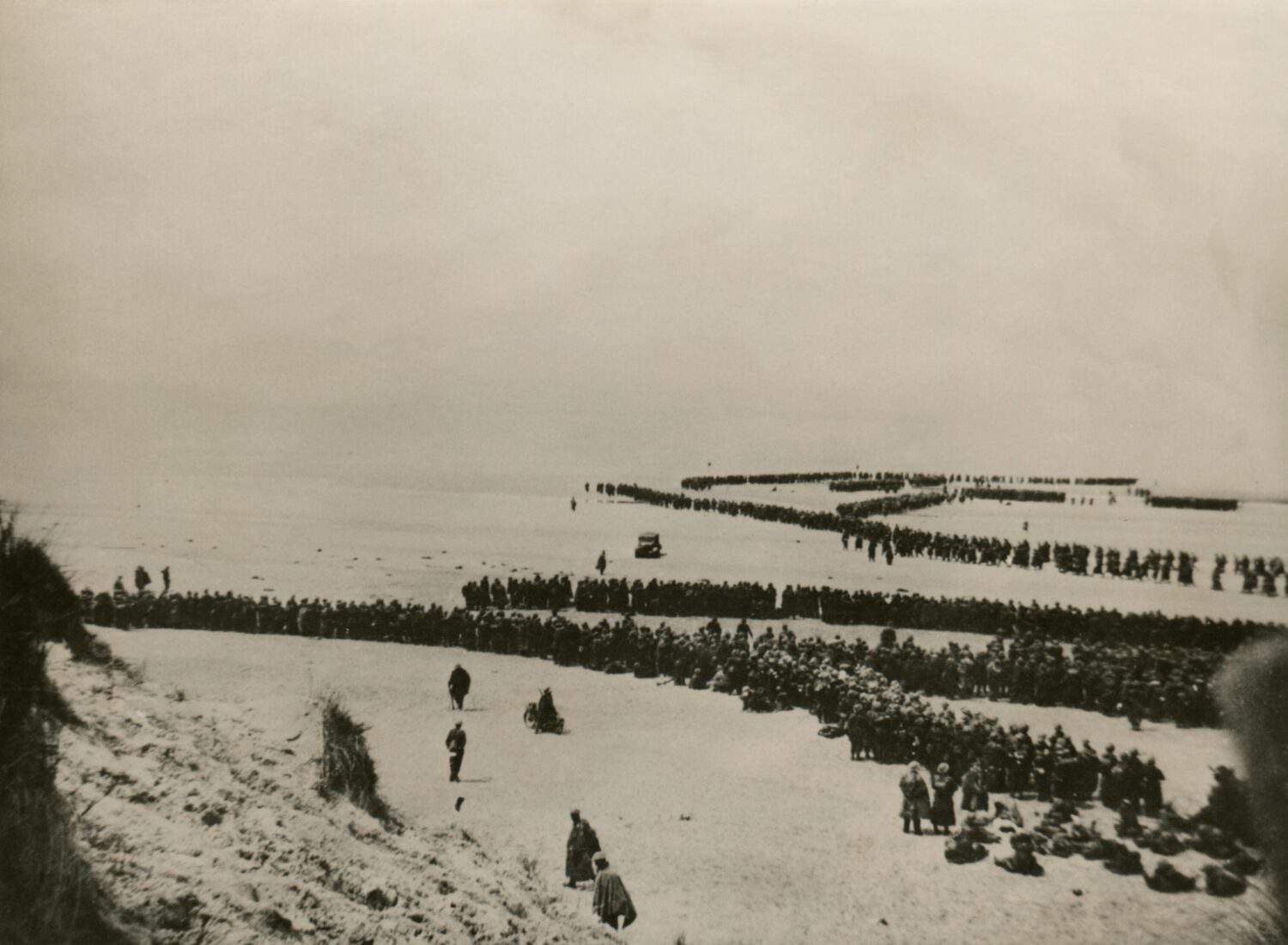 Military evacuation of Dunkirk during World War 2. Thousands of British and French troops wait on the dunes of Dunkirk beach for transport to England. May 26-June 4, 1940.