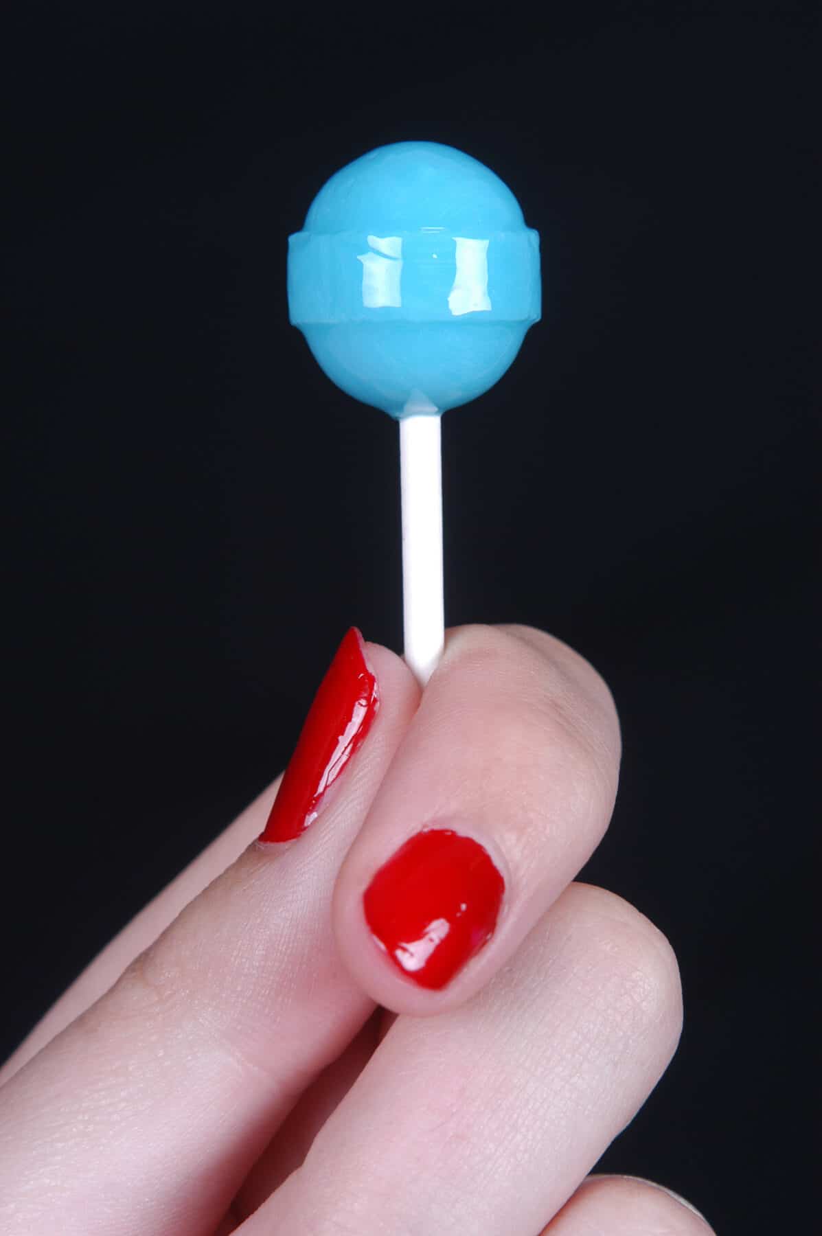 woman holding lollipop