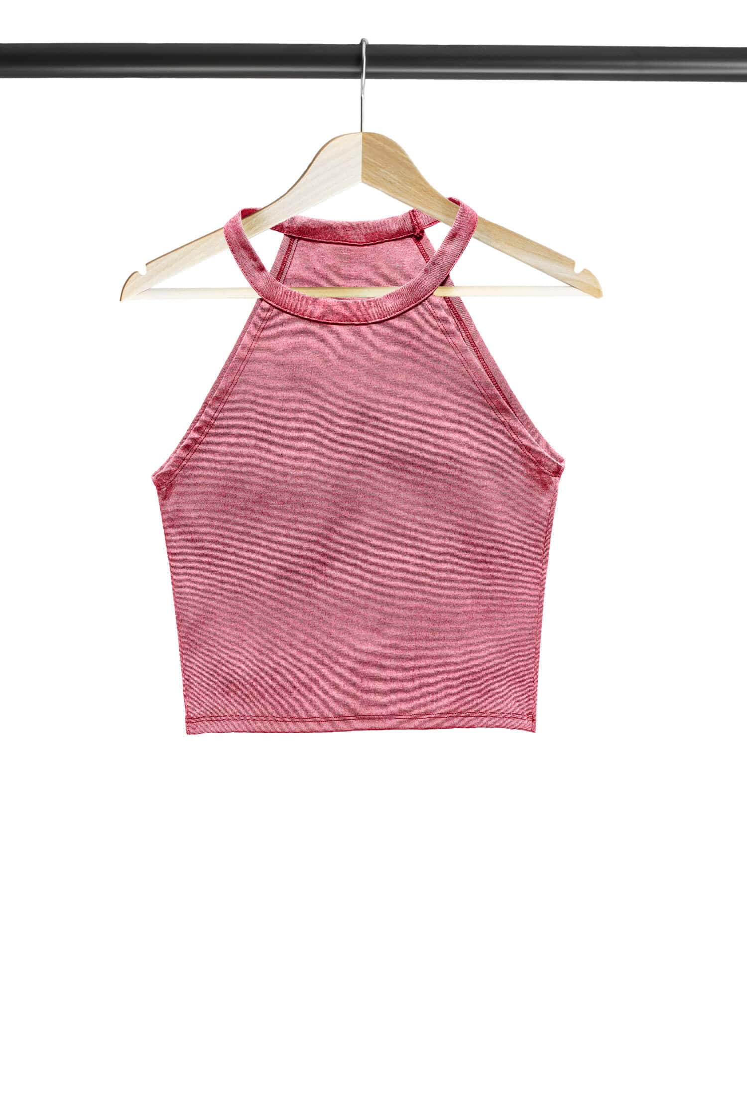 Pink crop top on wooden clothes rack isolated over white
