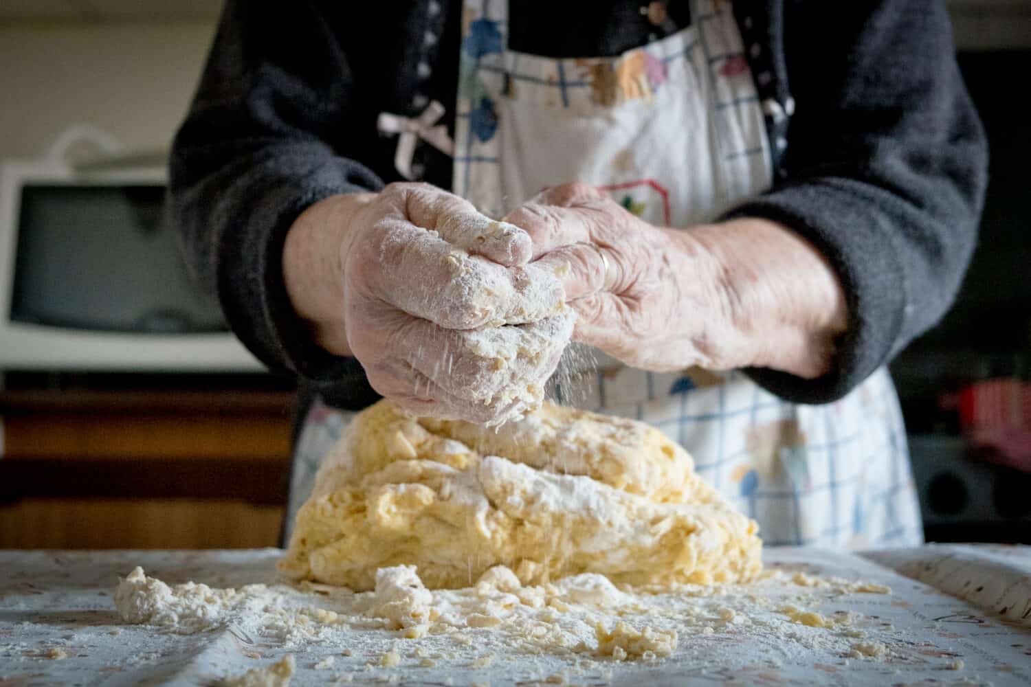 grandma making pasta the old traditional way in her home