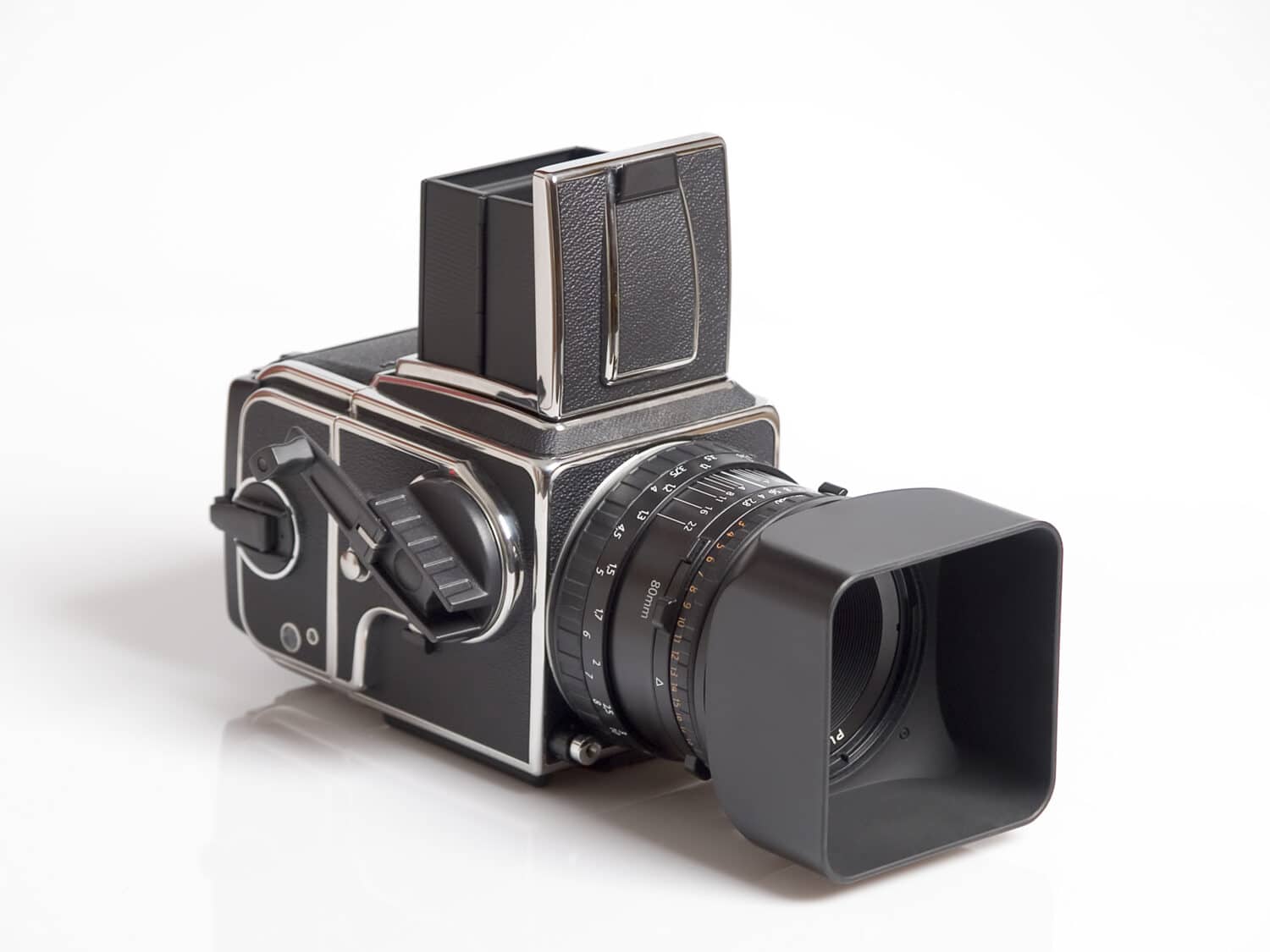 The photo shows a medium format camera over white