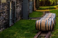 Newly filled bourbon barrels on rail to be transported to warehouse for aging in Kentucky.