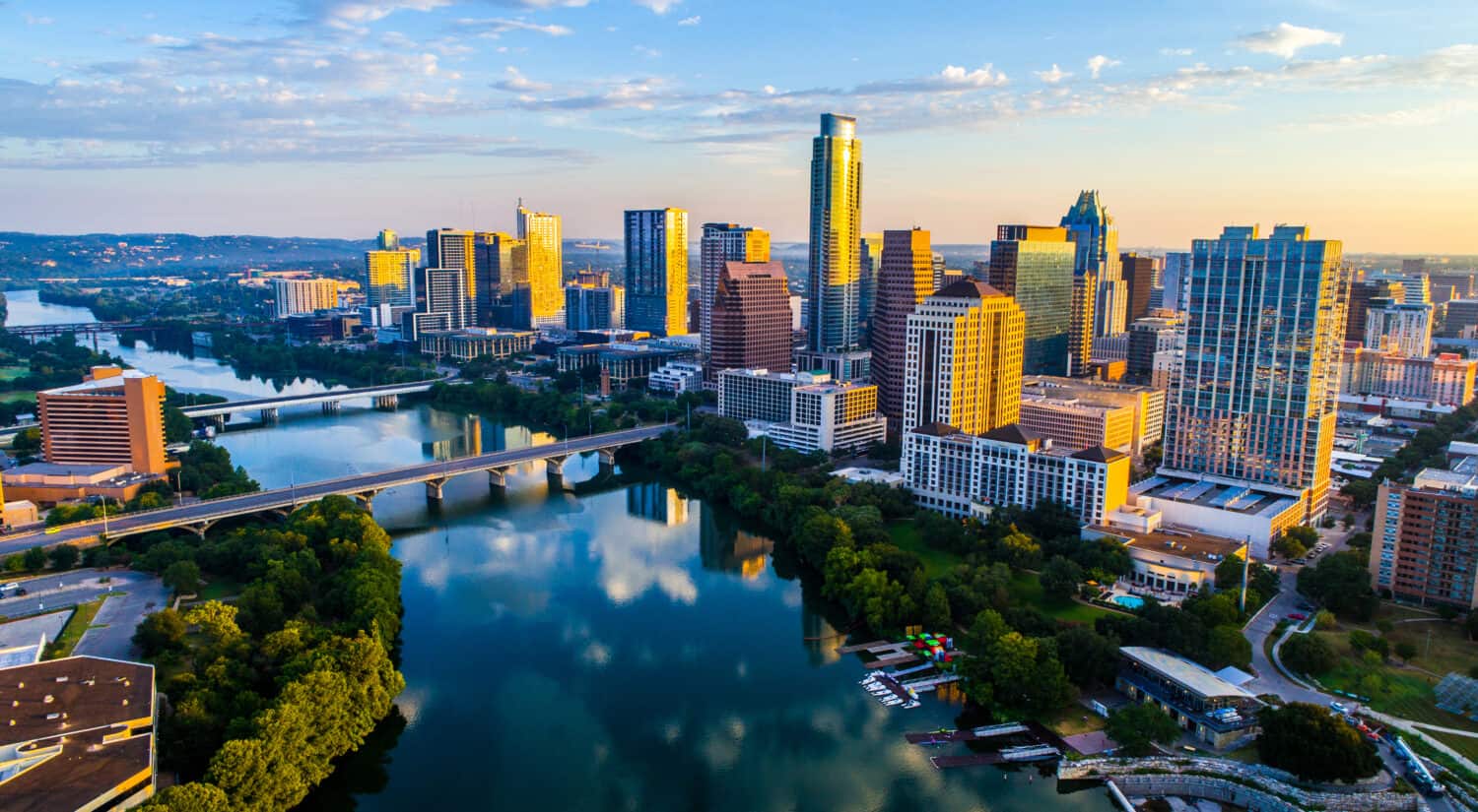 Austin Texas USA sunrise skyline cityscape over Town Lake or Lady Bird Lake with amazing reflection. Skyscrapers and Texas capital building in distance you can see the entire city during summer