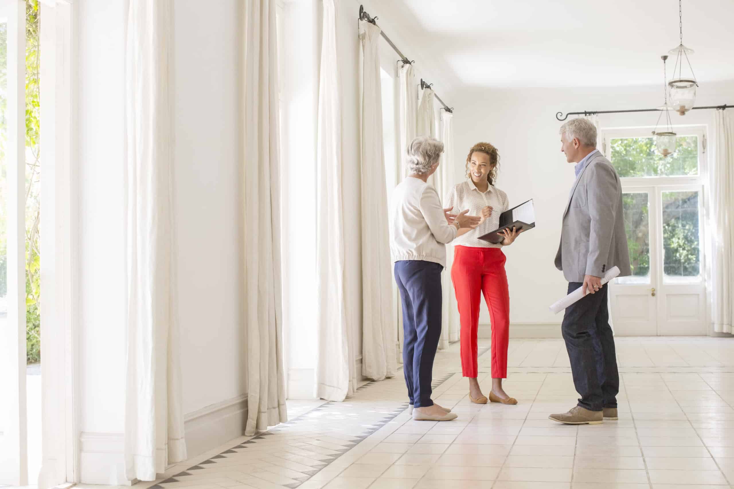 Older couple talking with woman in living space