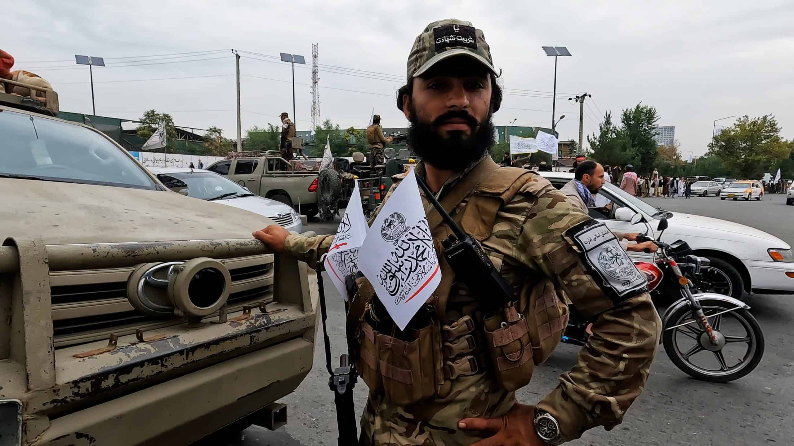 Taliban member with chest flags