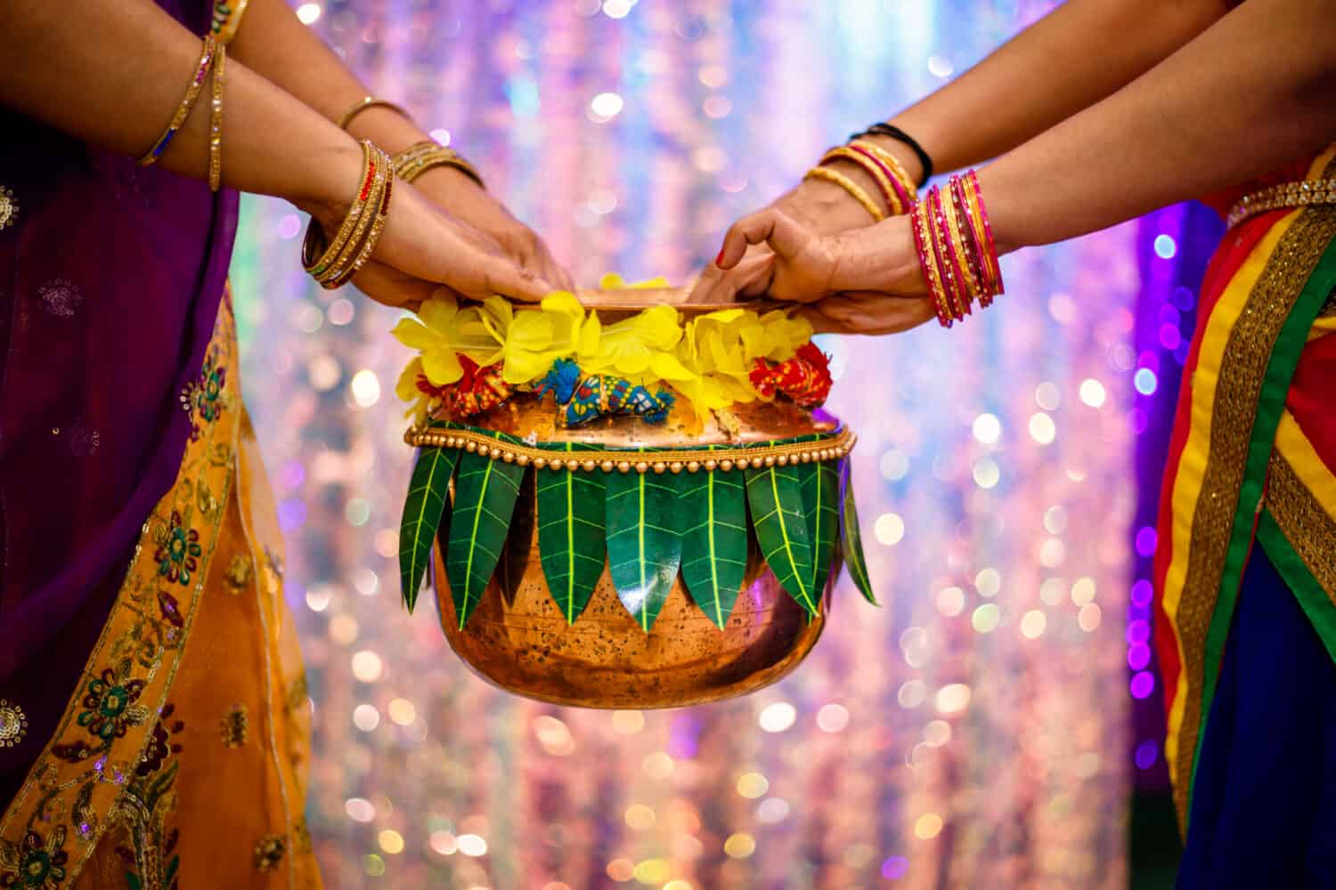 Two girls holding a decorated metal pot in wedding celebration. Girls dancing in Indian wedding - Image