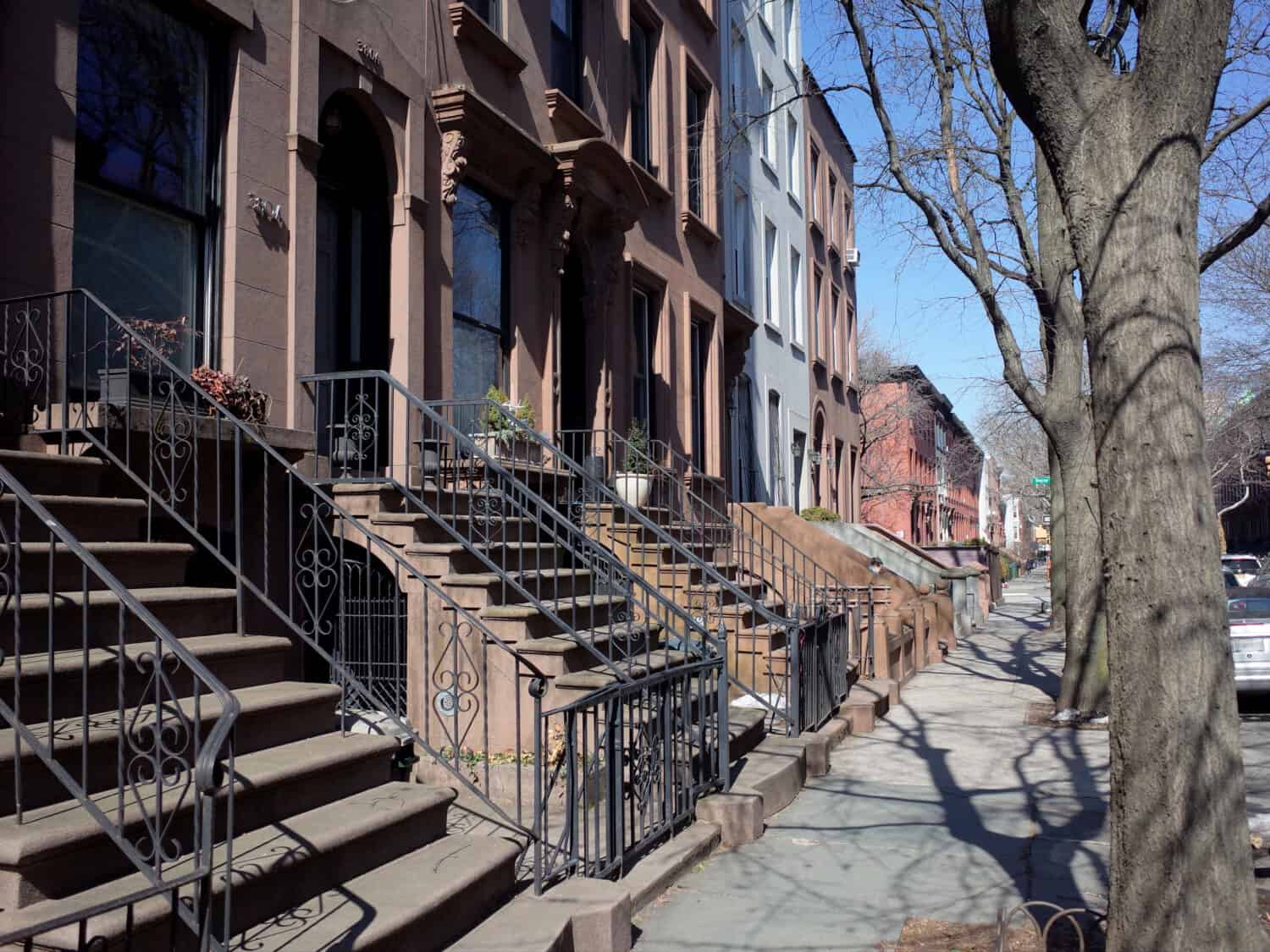 Brownstone houses on a street in the up and coming neighborhood of Cobble Hill, Brooklyn, NYC