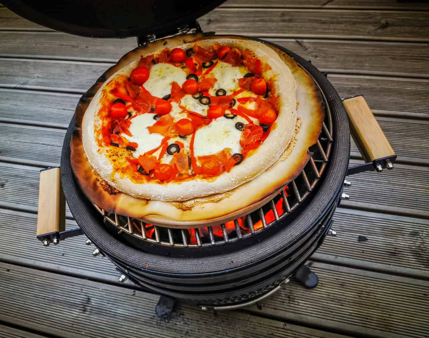 Homemade pizza baked on a kamado cook stove