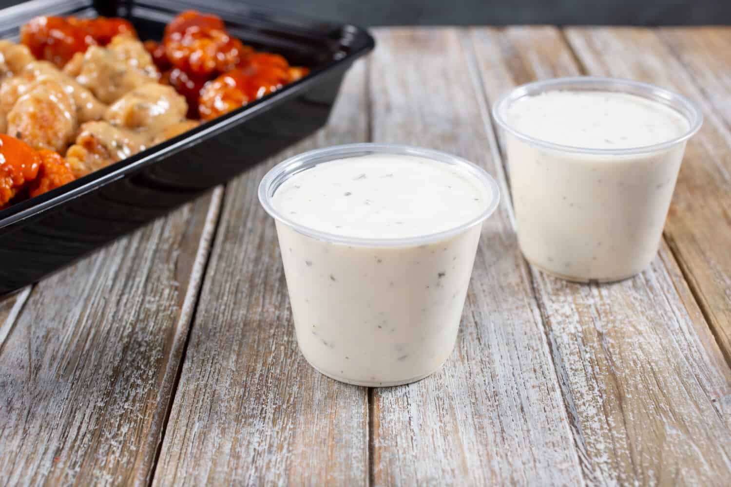 A view of ranch dressing condiment cups.