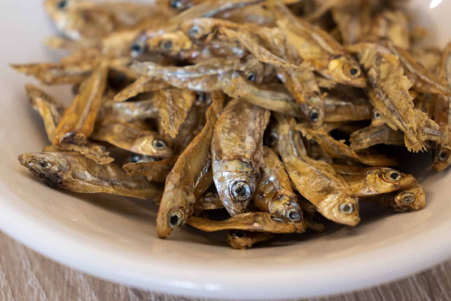 Closeup of dry charales over a white plate. Dried charales. Dried fish.