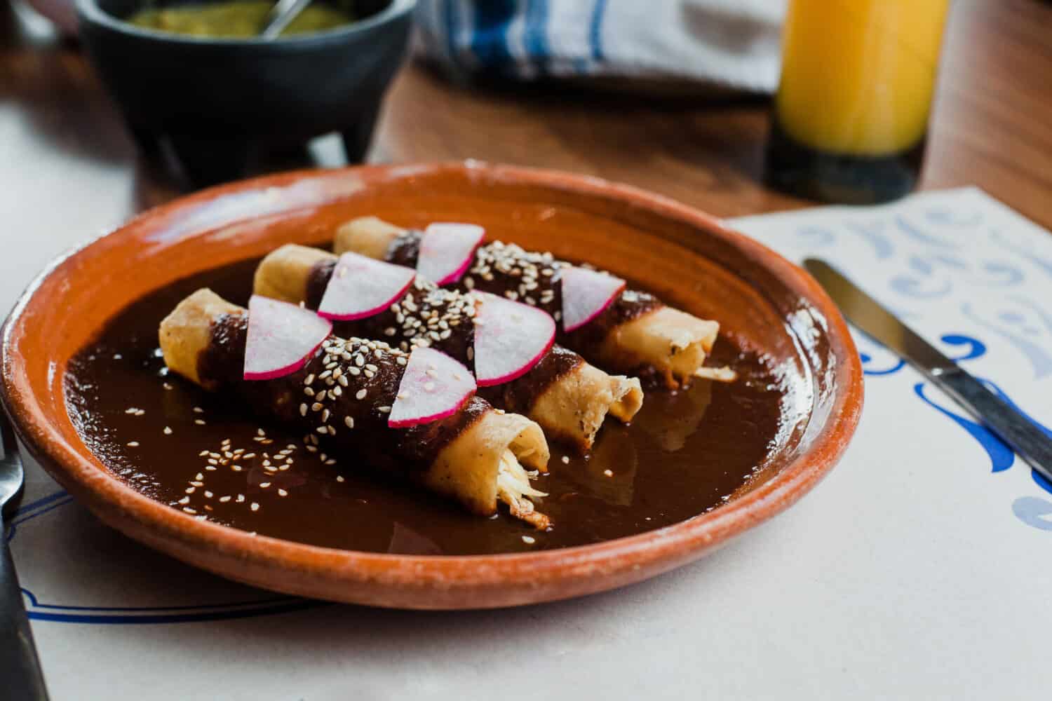 Envueltos de mole poblano or enchiladas with chicken, traditional mexican food in Mexico City