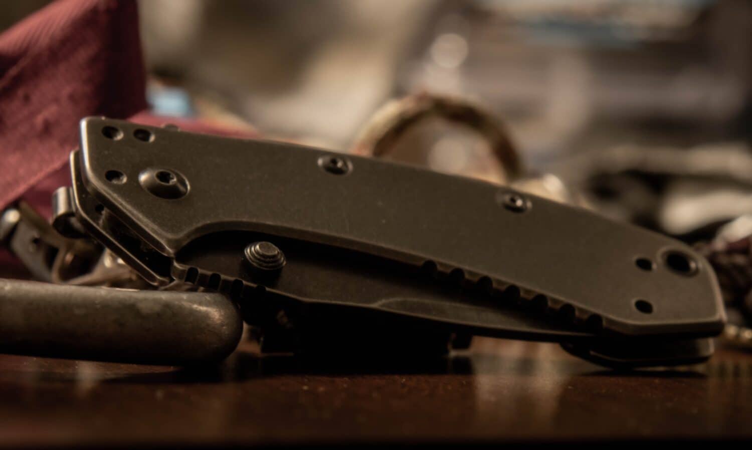A Kershaw knife rests among a pile of equipment.