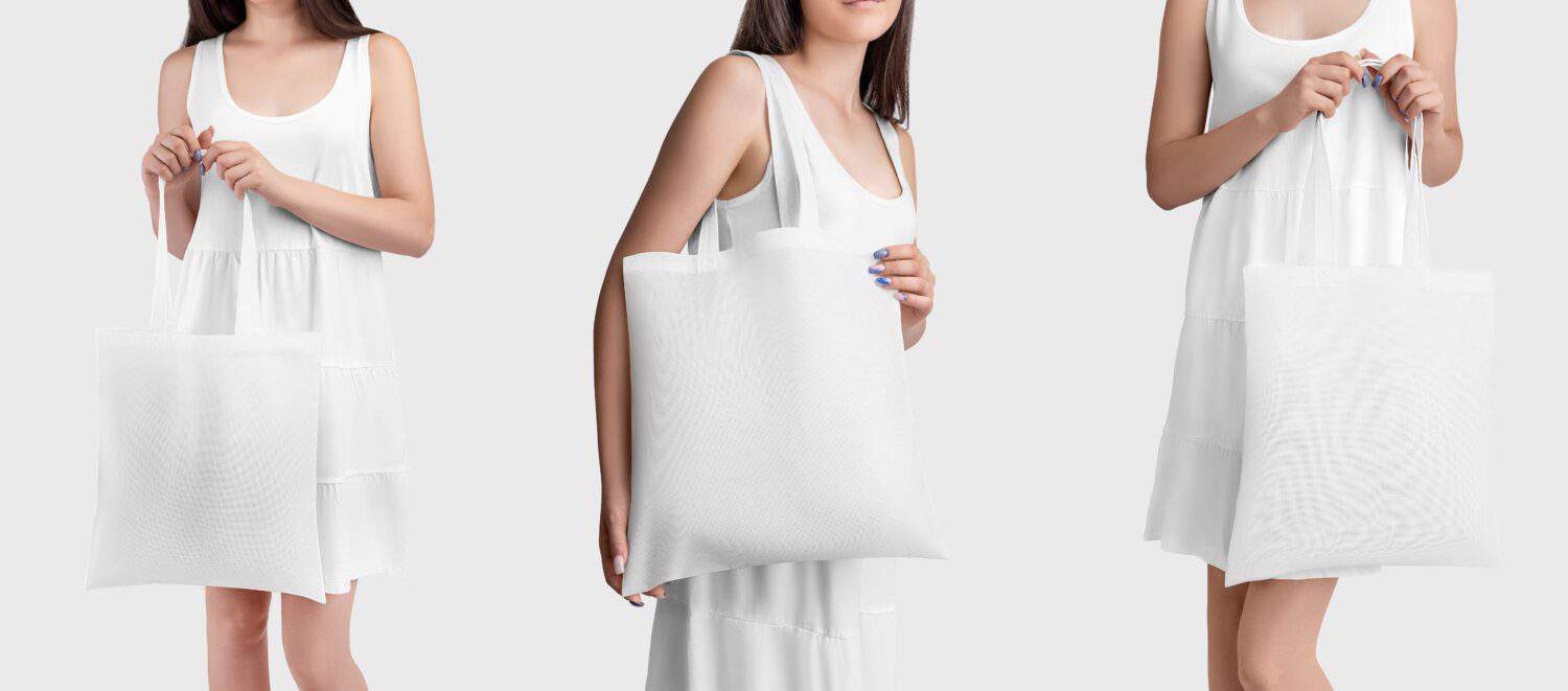 Mockup of a white totebag in the hands of a girl in a sundress, with space for design, pattern. Set of cotton ecobag for retail, shopping, isolated on background. Ecological sack template with handles