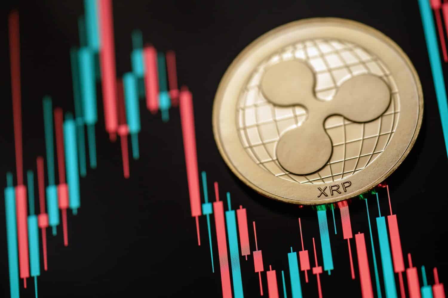 Gold Ripple (XRP) cryptocurrency with candle stick graph chart and digital background.