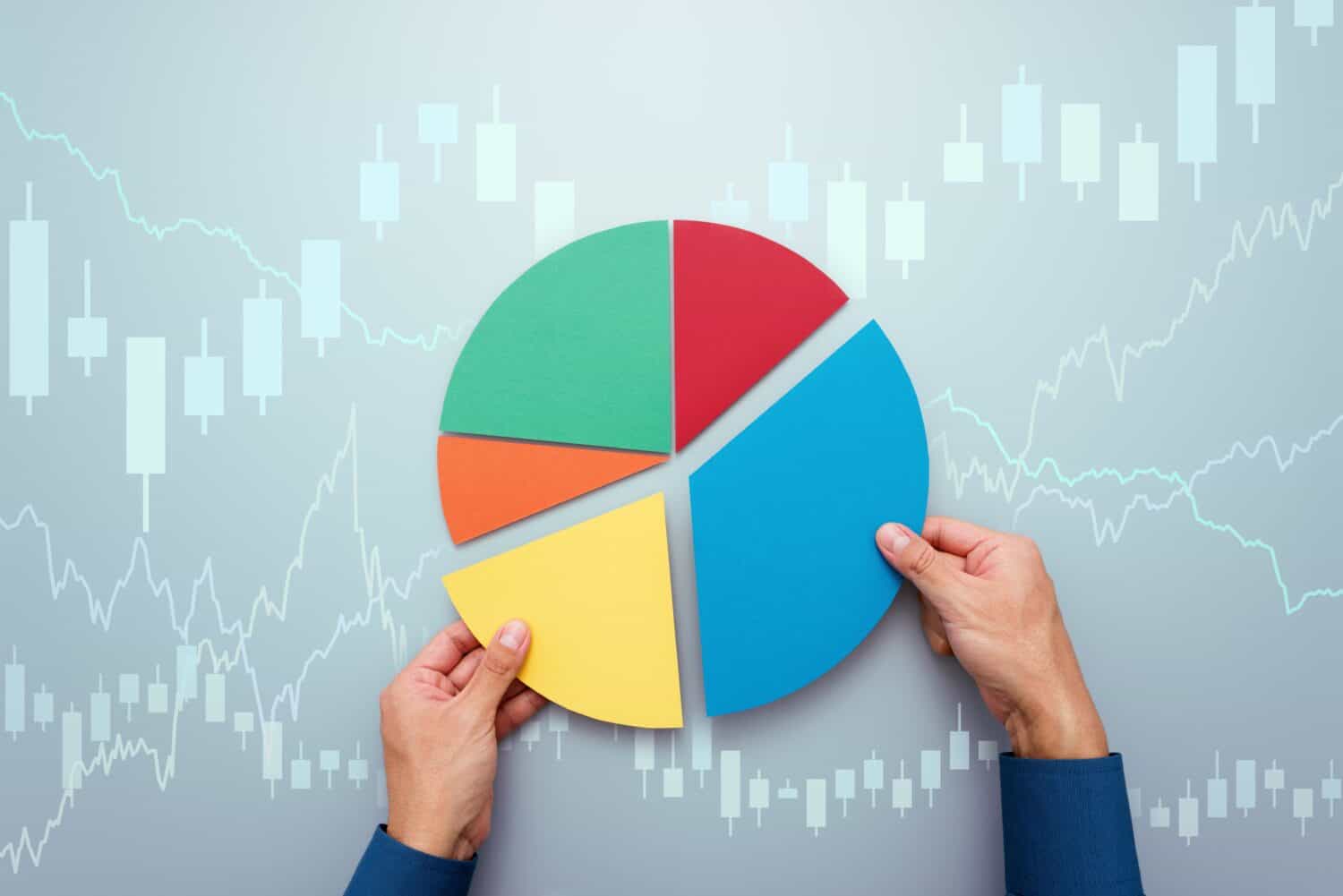 Strategy of diversified investment. Investor managing portfolio. Pie chart and candlestick charts.