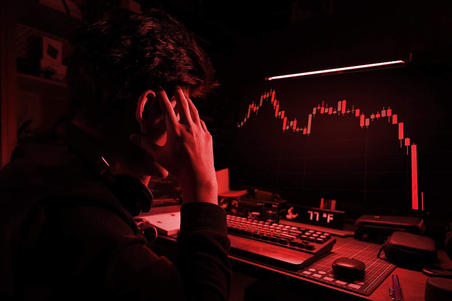Stress Business man look at the Computer Screen, The red crashing market volatility of crypto trading with technical graph and indicator, red candlesticks going down without resistance, market crash,