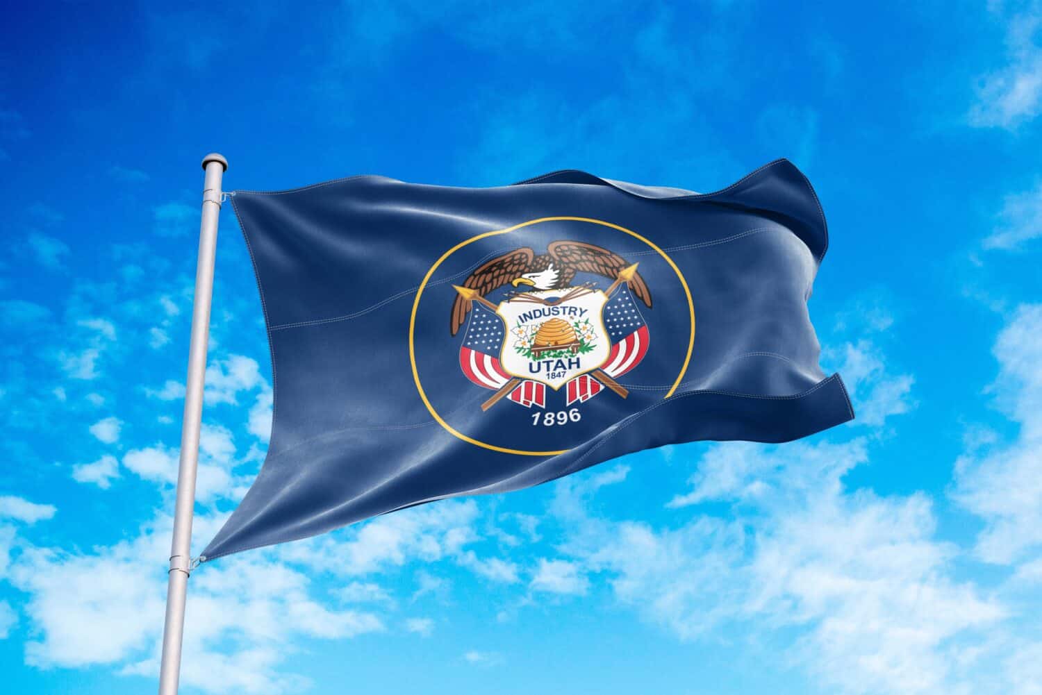 Utah flag waving in the wind, blue sky background