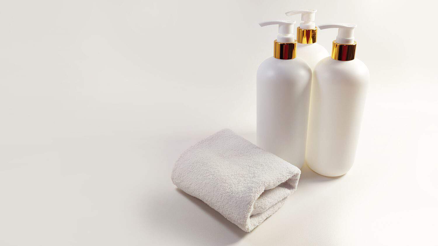 Elegant and Luxurious white gold pump bottles with a clean white towel