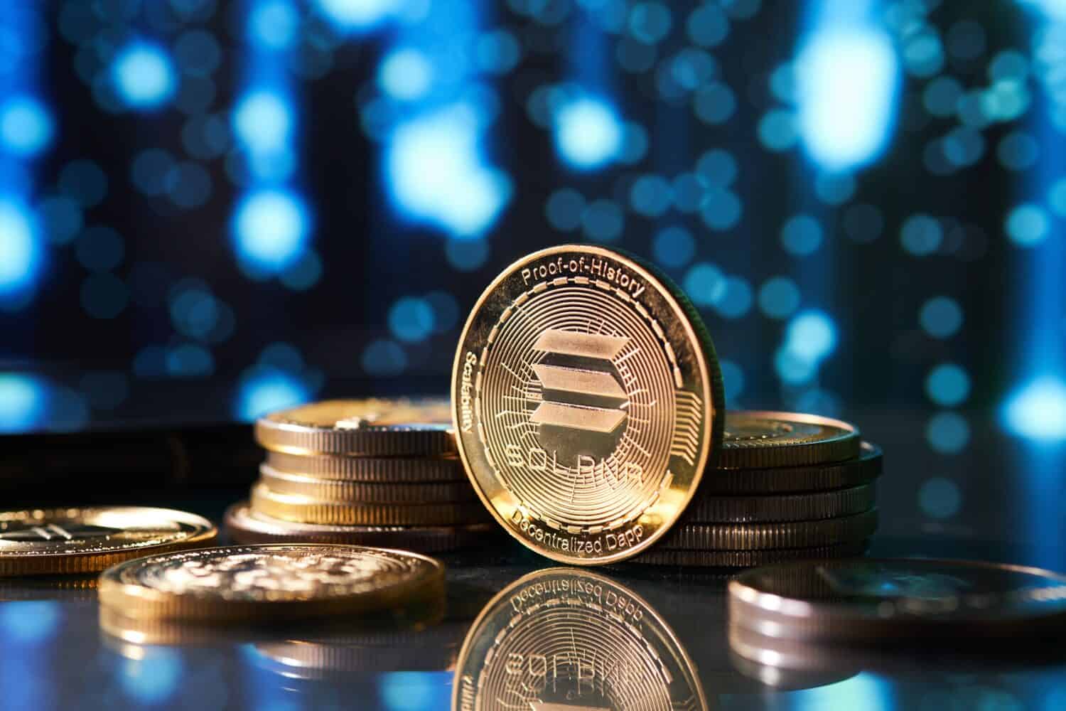 Closeup of golden Solana cryptocurrency surrounded by more coins and defocused stars background