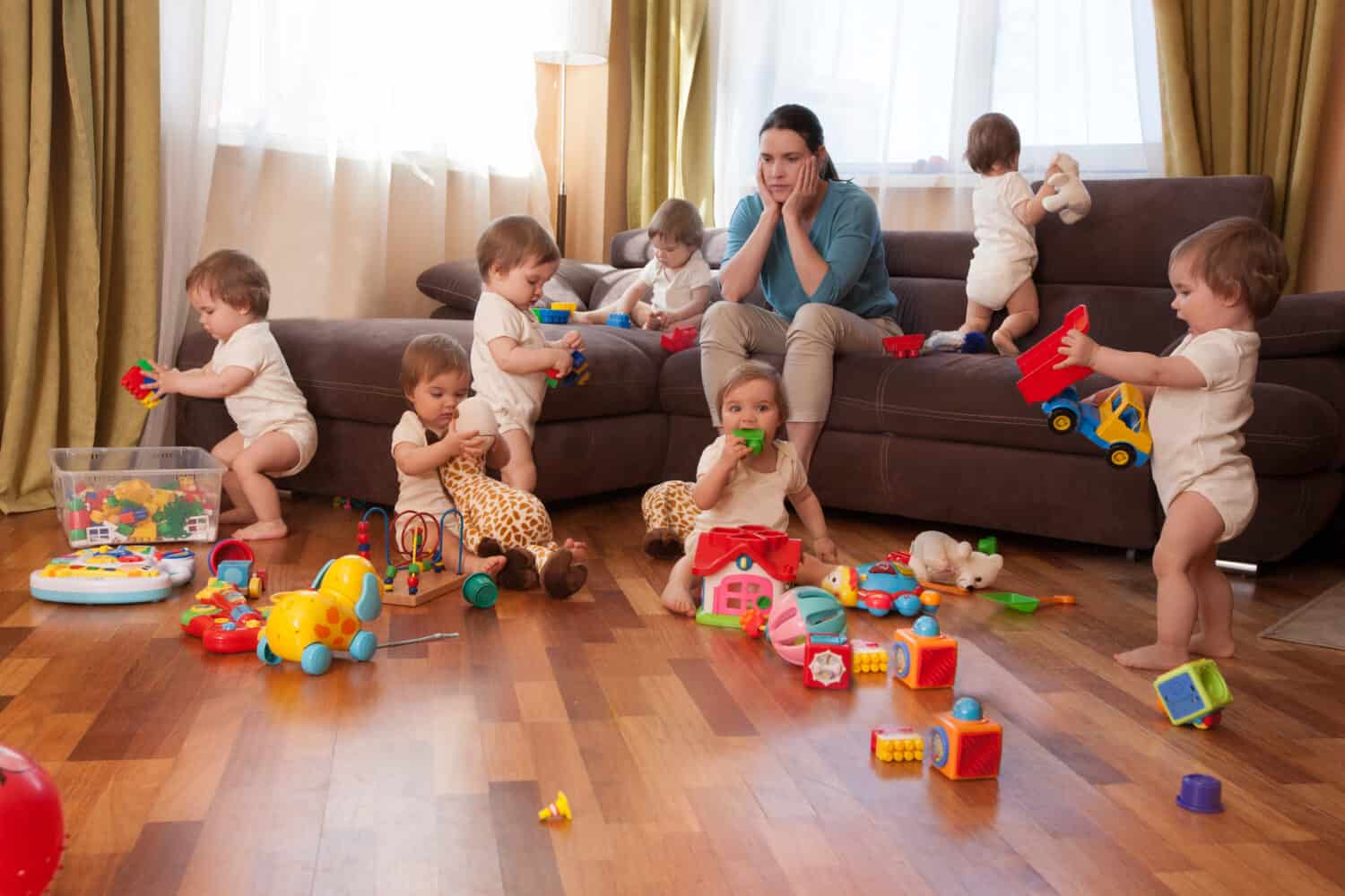 Woman sitting on a sofa in a room with several children