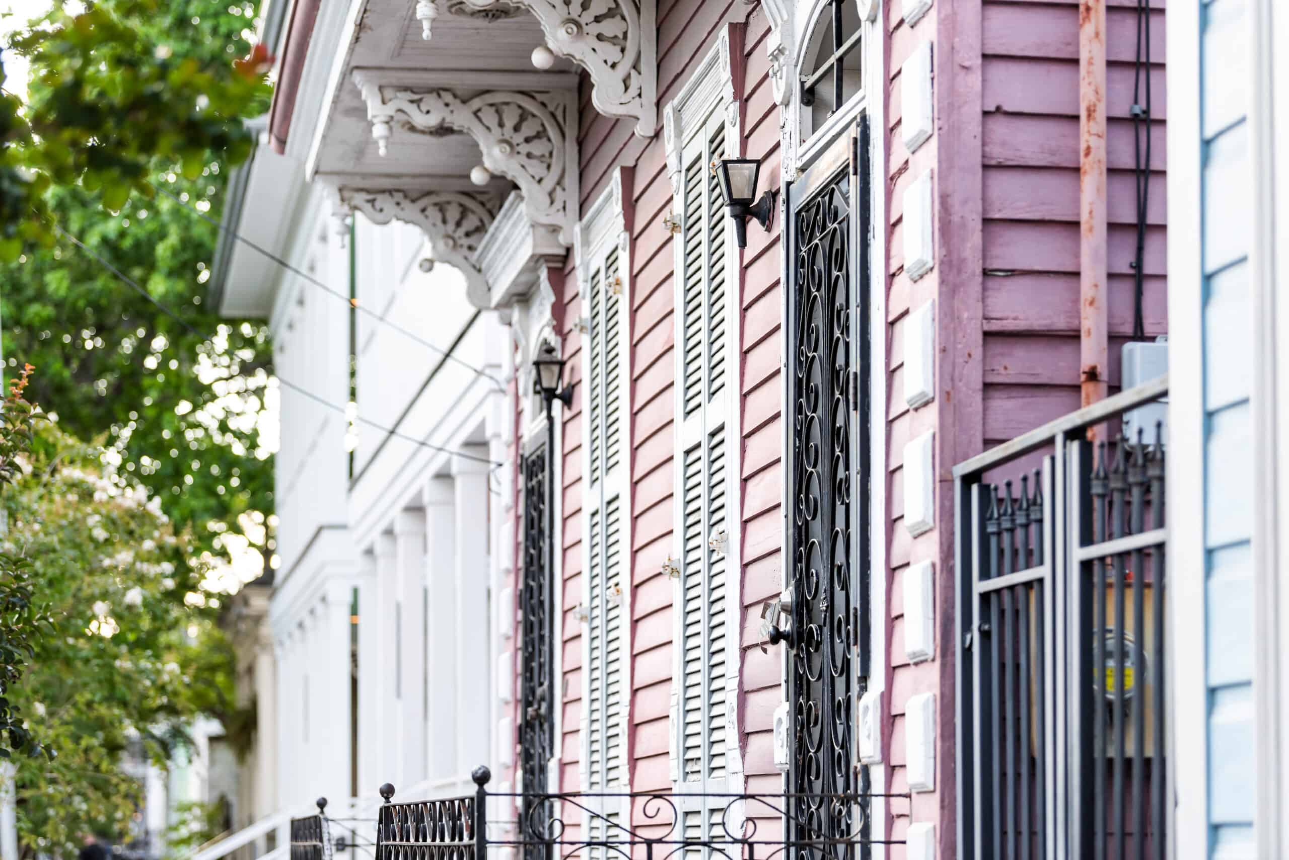 New Orleans, USA Old street historic district in Louisiana famous town, city, pink painted house wall colorful entrance, building nobody on sidewalk