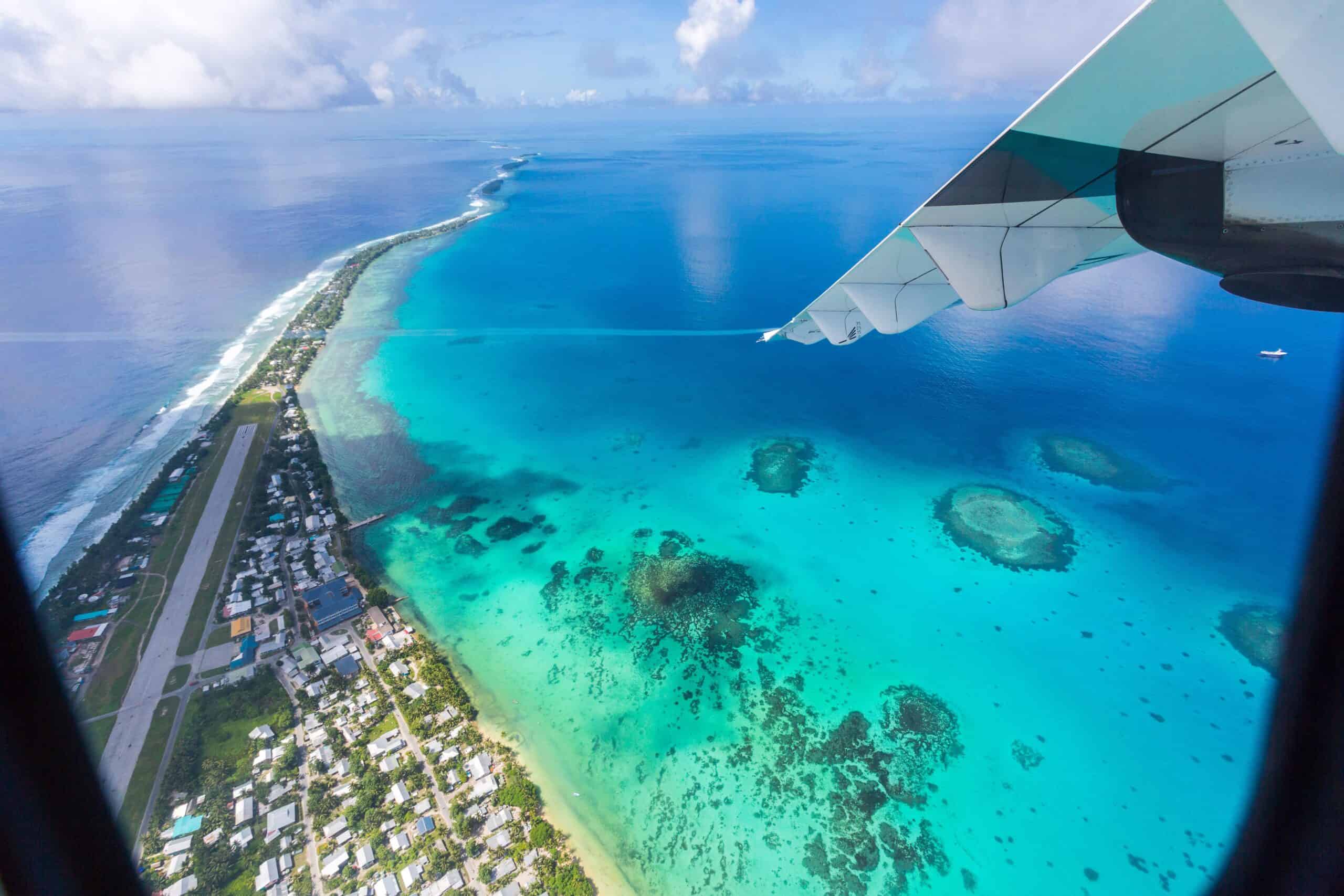 Tuvalu | Tuvalu under the wing of an airplane, aerial view of airport. Vaiaku, Fongafale motu, Funafuti atoll, Tuvalu, Polynesia, South Pacific Ocean, Oceania