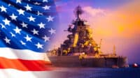 Military parade of American troops. A warship with sailors on the deck against the background of the us flag. American fleet. The naval forces of America. Protection of the country's water borders.