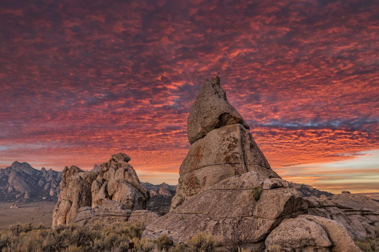 Beautiful sunset with colorful orange and purple clouds setting over the natural rock formations of City Of Rocks National Reserve, in Southern Idaho, no people, large jpeg