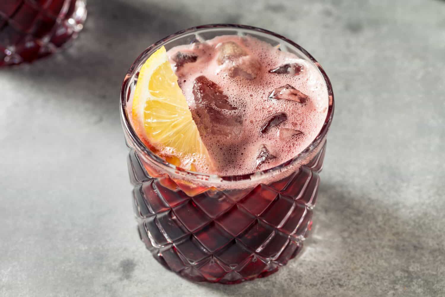Boozy Kalimotxo Red Wine and Cola with a Lemon Garnish
