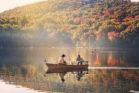 fishermen fishing in a lake in the early morning