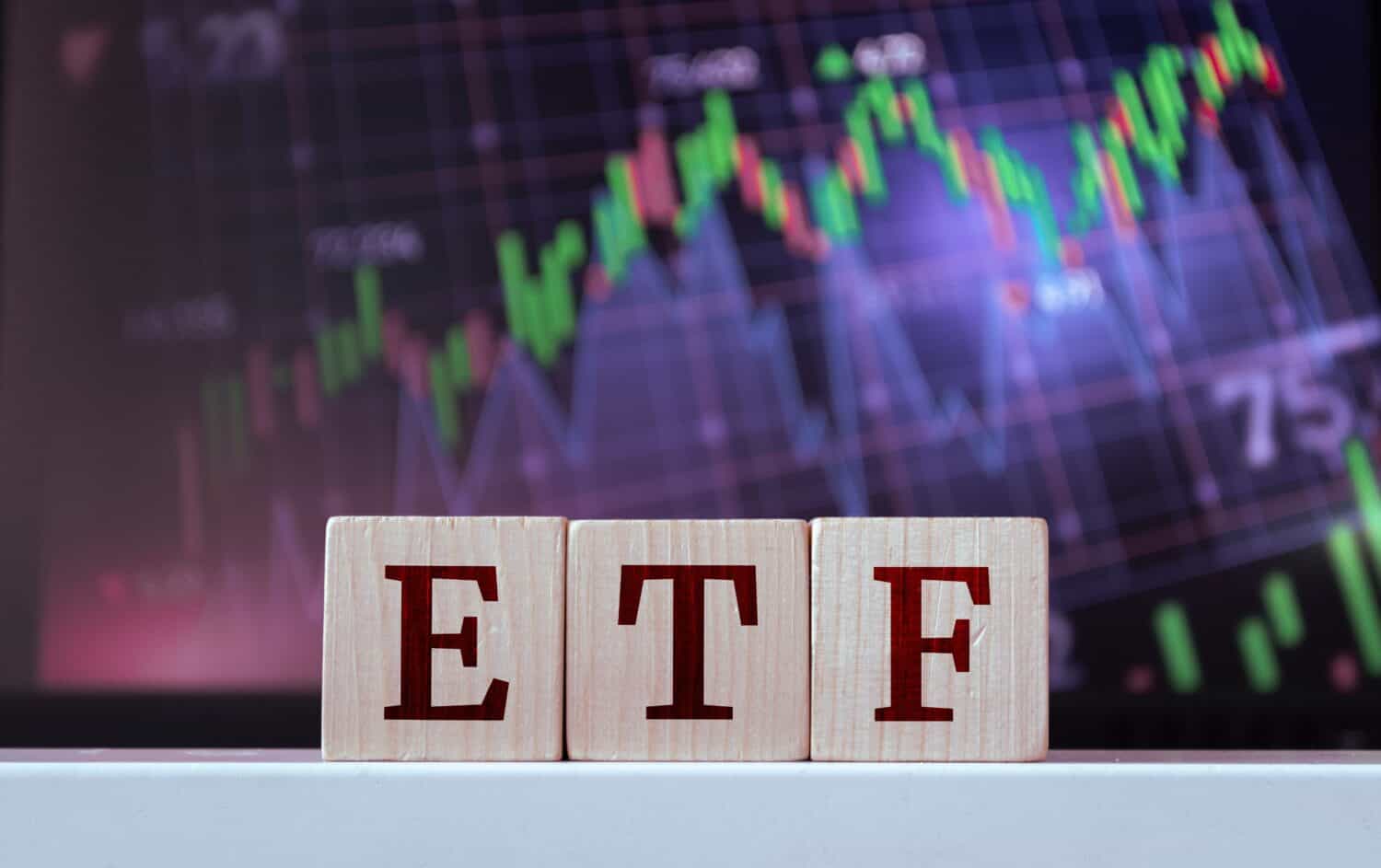 ETF - acronym from wooden blocks with letters, Exchange-traded fund. Financial market concept