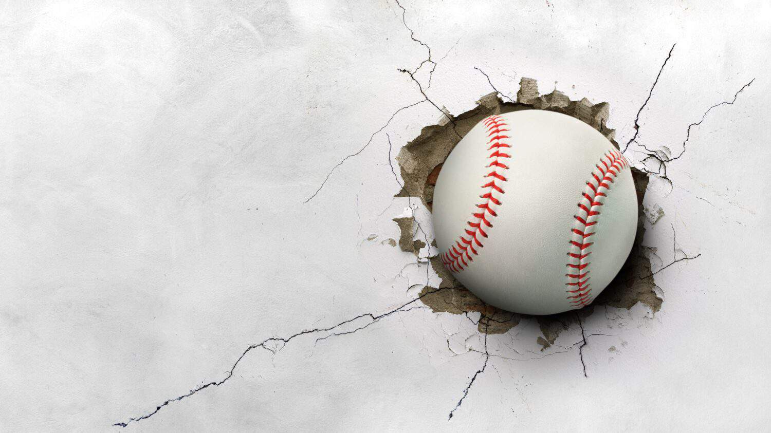 A baseball hits through a cement wall. concept of strength