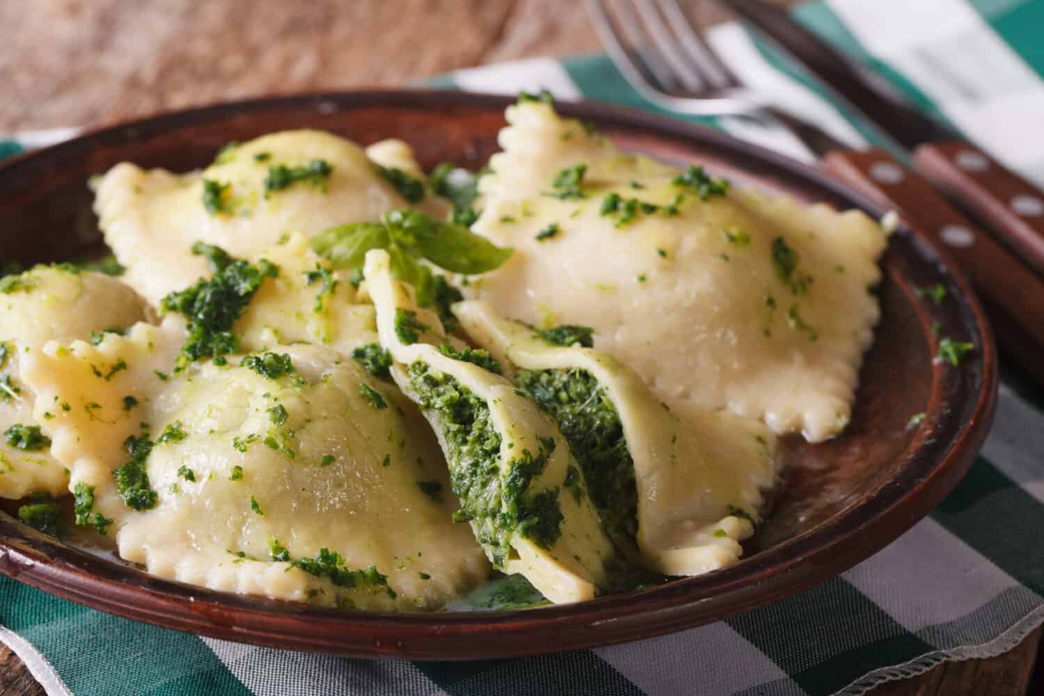 Italian ravioli with spinach and cheese close-up on a brown plate. horizontal, rustic style
