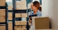 Shipping, receiving, and inventory clerks workers | Asian businesswoman standing front of shelf use digital tablet check stock on shelf and key data in online information detail in before express delivery at warehouse.
