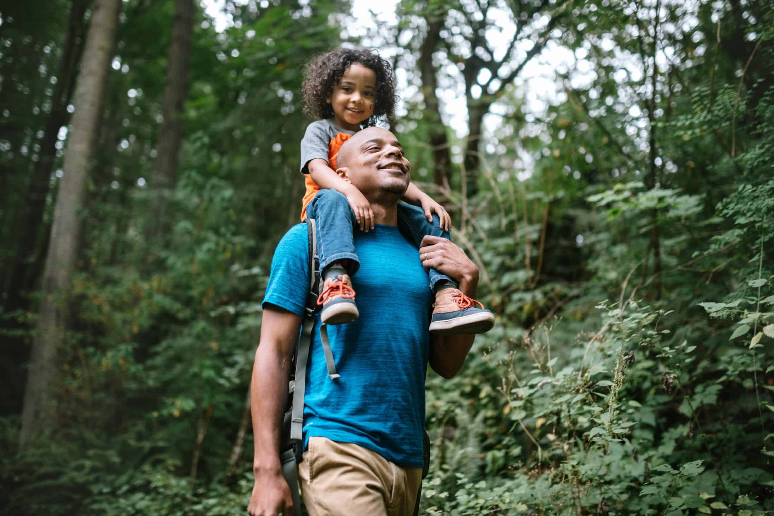Washington people | Father Carries Son On Hike Through Forest Trail in Pacific Northwest