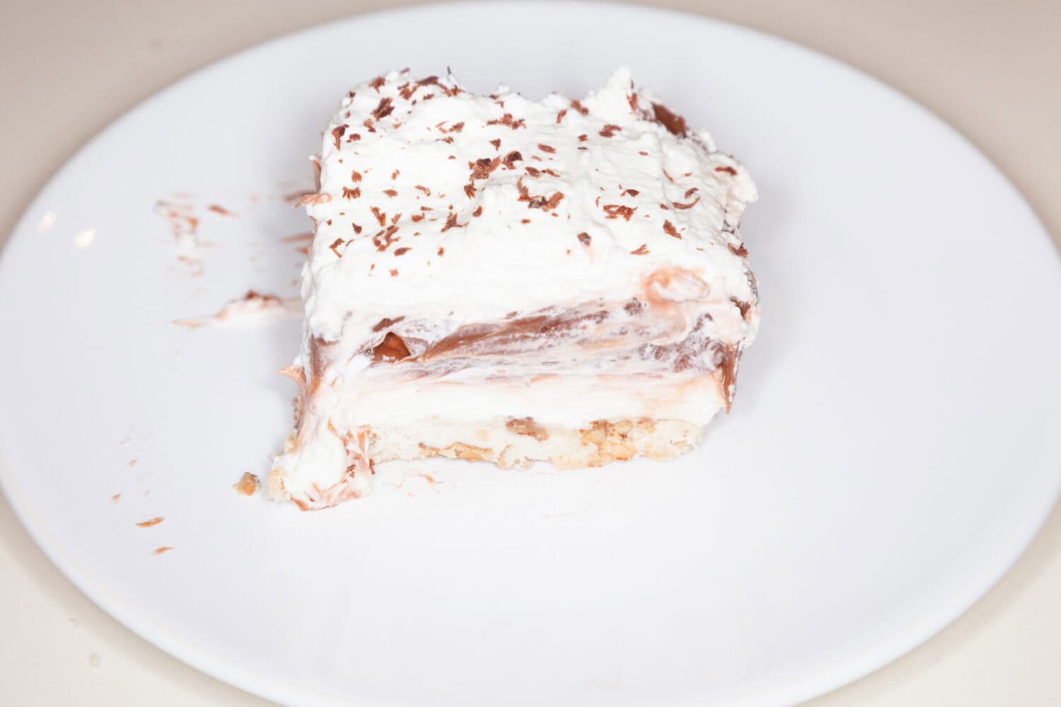 This is a creamy pudding-like pie. It has thick chocolate filling, thick cream cheese filling, a butter/nut crust, and is topped with whipped cream.