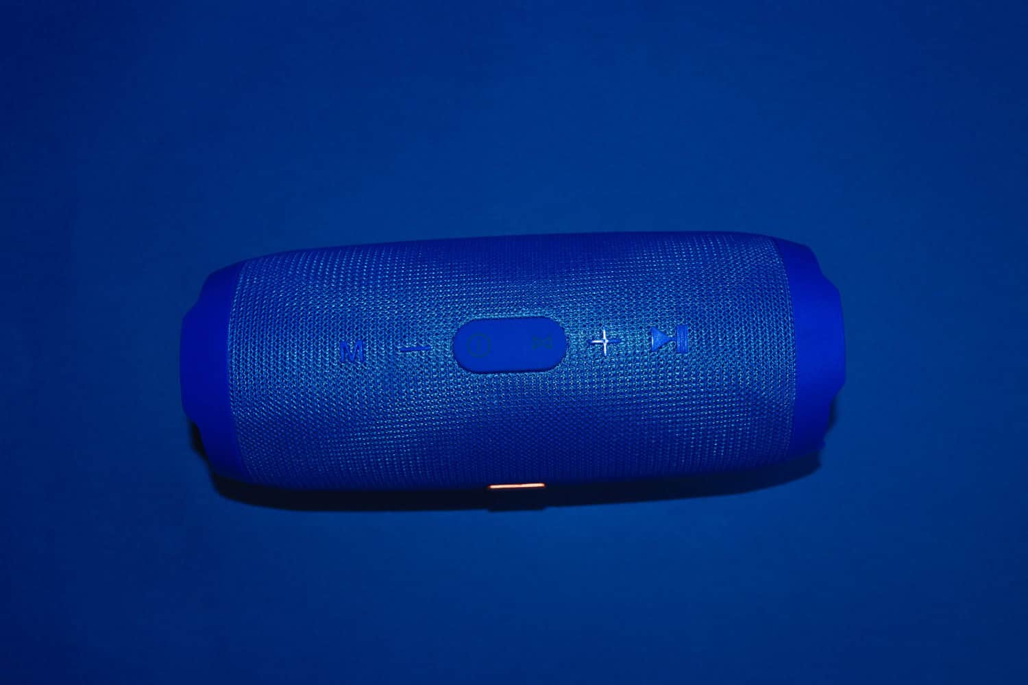 blue bluetooth speaker on blue background