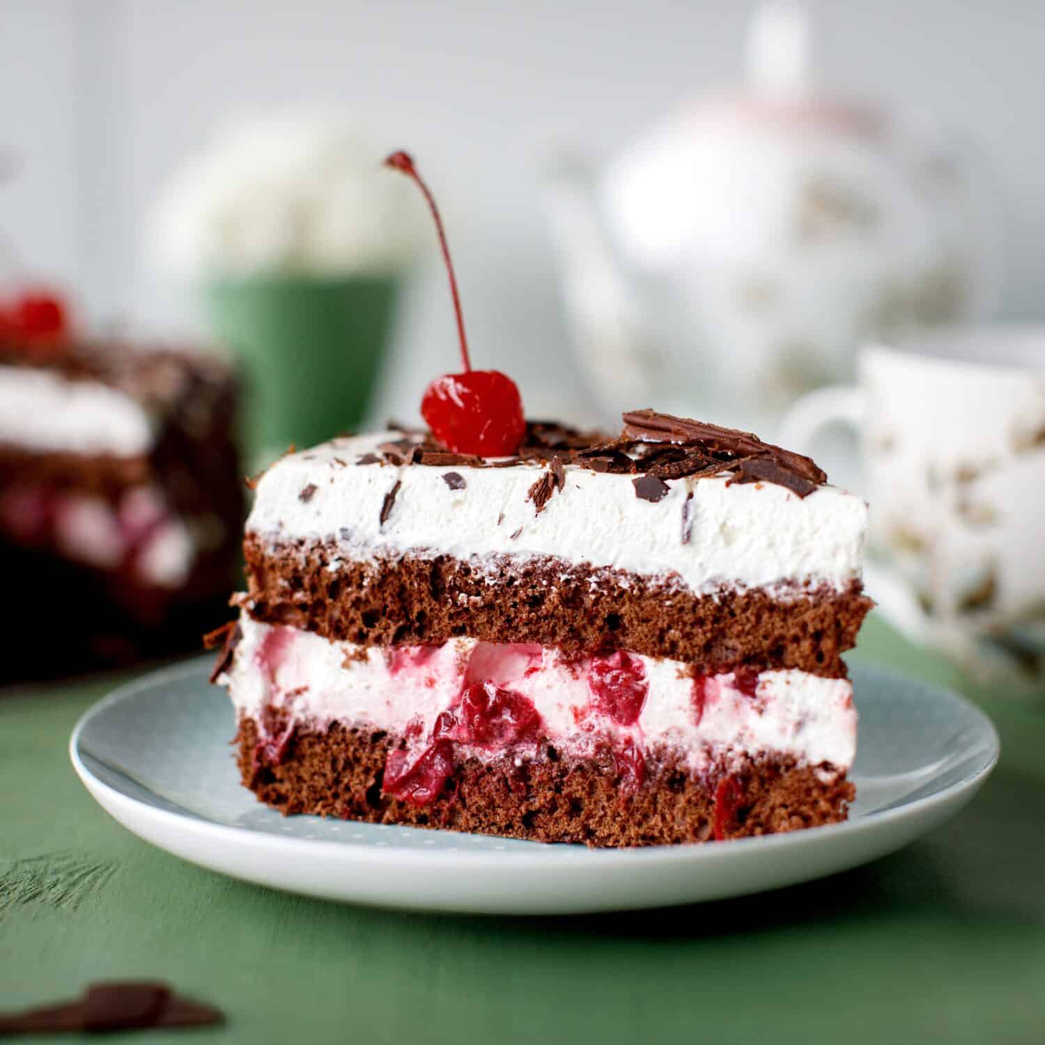 Cherry cake and chocolate on the background with flowers