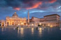 Vatican City, Rome, Italy. Cityscape image of illuminated Saint Peter's Basilica and St. Peter's Square, Vatican City, Rome, Italy at sunrise.
