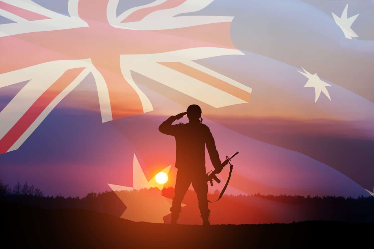 Silhouette of soldier saluting on background of Australia flag and the sunset or the sunrise background. Anzac Day. Remembrance Day.