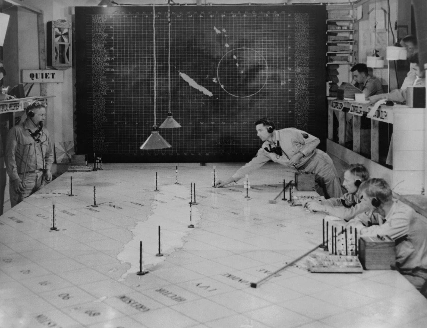 U.S. Army Signal Corps using radar plotting board. They track aircraft at 1st Island Command Headquarters, Noumea, New Caledonia. 1943.