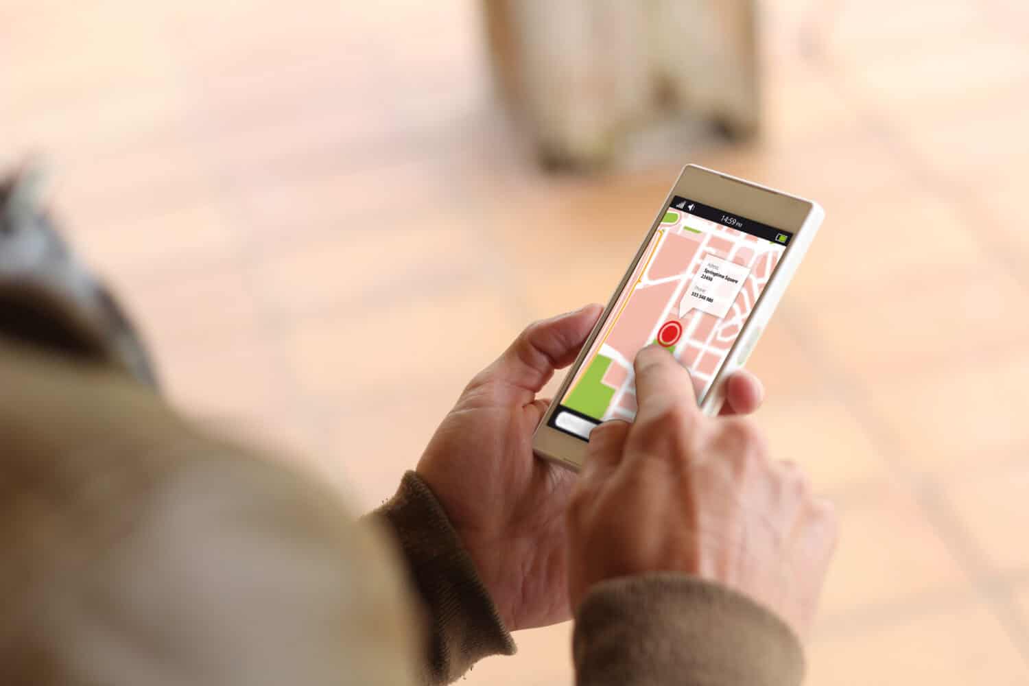 man touching the screen of his smartphone showing gps app. All screen graphics are made up.