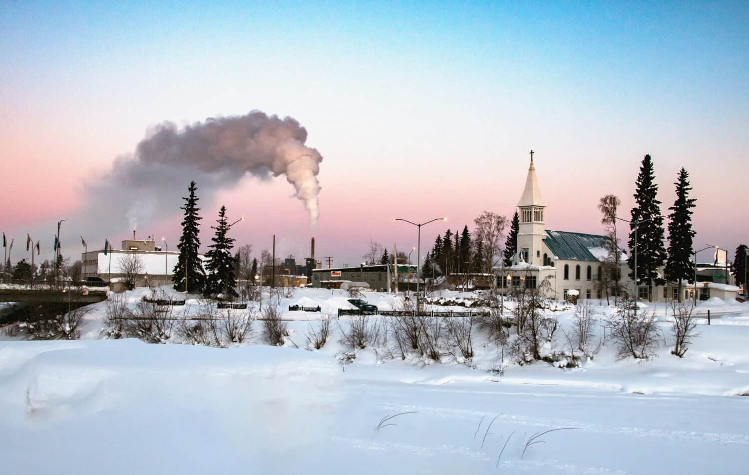 view of downtown fairbanks alaska across frozen chena river on clear winter morning