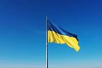 Ukraine | The flag of Ukraine develops on a flagpole against a background of clear sky