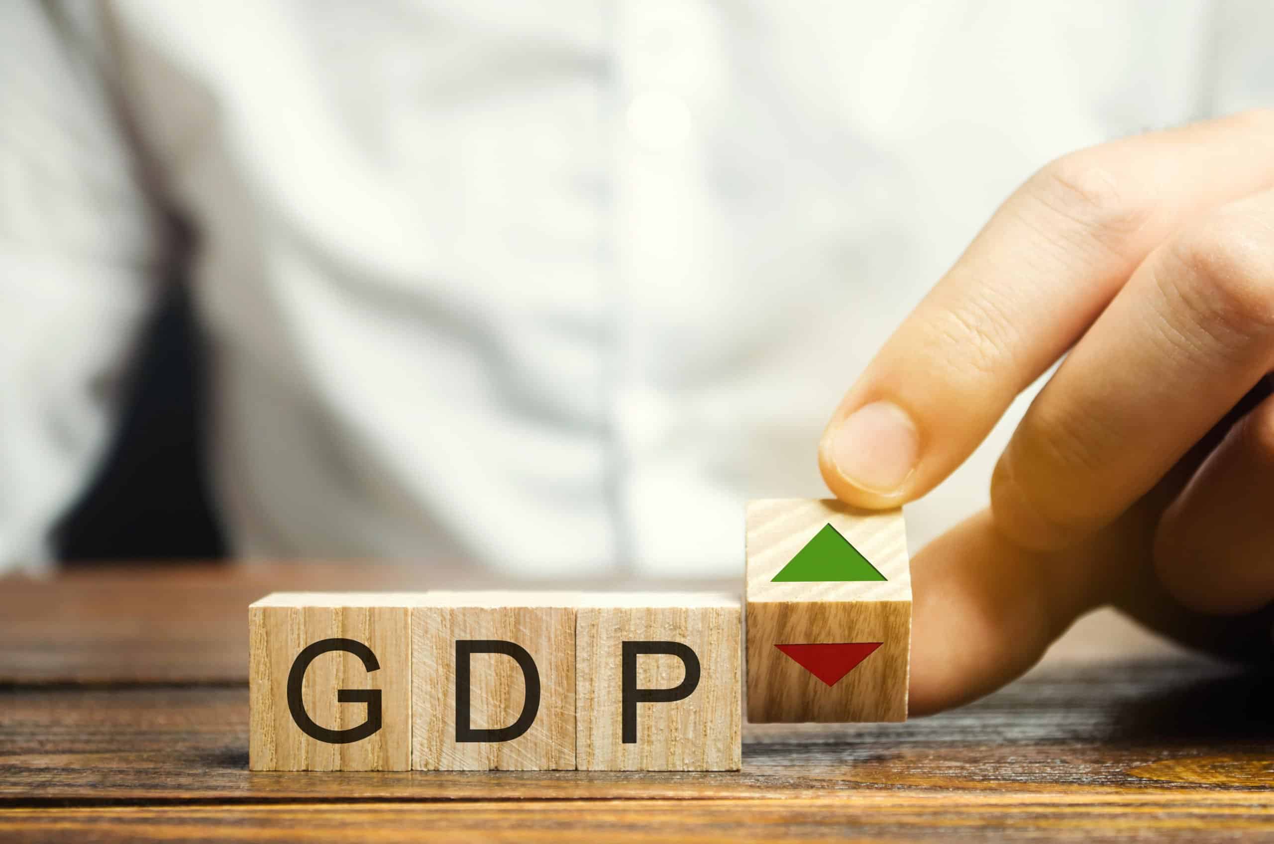 Gross Domestic Products | Wooden blocks with the word GDP and up and down arrows. An unstable economy in the country. The financial measure of the market value of all final goods and services produced in a given period.